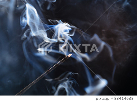 smoke from an aromatic stick on a black background. 83414638