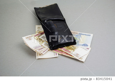 Retro-black wallet and banknotes of 1000 and 100 rubles sticking out of it. Business and finance, the concept of wealth. Crisis 83415041