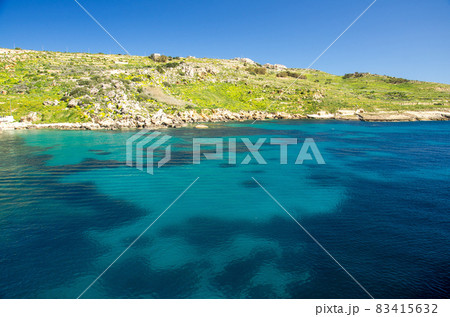 Vivid blue water in harbour near town Mgarr in Gozo island, Malta 83415632