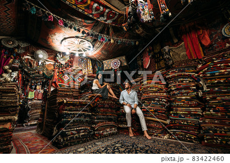 Guy and girl in the store. Couple in love in Turkey. Man and woman in the Eastern country. Gift shop. A couple in love travels. Persian shop. Tourists in store. Oriental carpet. Istanbul. Cappadocia 83422460