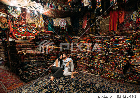 Couple having fun. Couple in love in Turkey. Man and woman in the Eastern country. Gift shop. A couple in love travels. Persian shop. Tourists in store. Oriental carpet. Cappadocia. Morocco Couple having fun. Couple in love in Turkey. Man and woman in the Eastern country. Gift shop. A couple in love travels. Persian shop. Tourists in store. Oriental carpet. Cappadocia. Morocco 83422461