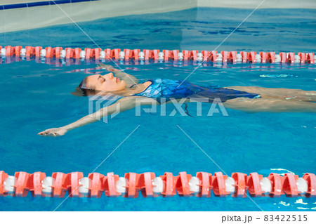 Young professional swimmer woman swimming in indoor pool Young professional swimmer woman swimming in indoor pool 83422515