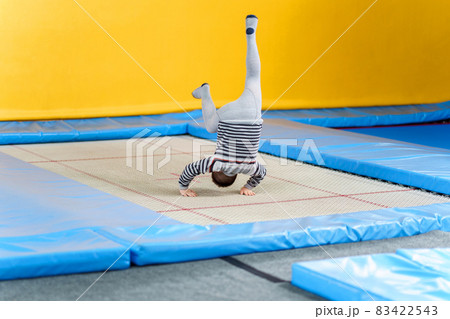 Happy smiling small kids jumping on indoors trampoline in entertainment center Happy smiling small kids jumping on indoors trampoline in entertainment center 83422543