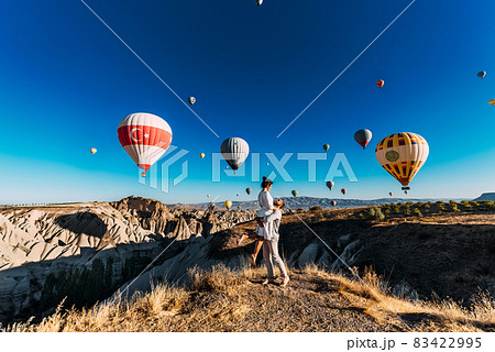 Happy couple in Cappadocia. The man proposed to the girl. Honeymoon in Cappadocia. Couple at the balloon festival. Honeymoon trip. Couple travels the world. The Landscapes Of Cappadocia 83422995