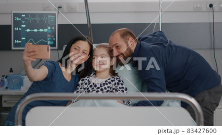 Positivity family taking selfie using modern smartphone during disease consultation Positivity family taking selfie using modern smartphone during disease consultation 83427600