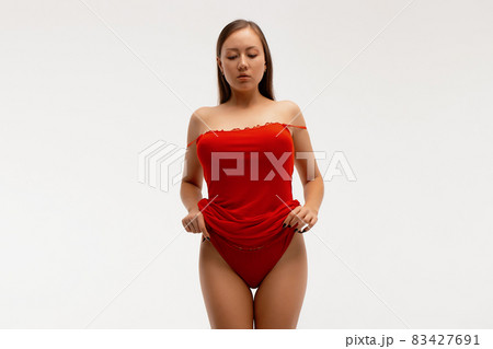 Alluring woman in red lingerie in studio 83427691