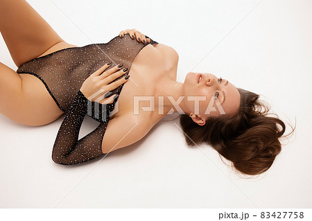Sensual woman lying on floor gracefully Sensual woman lying on floor gracefully 83427758