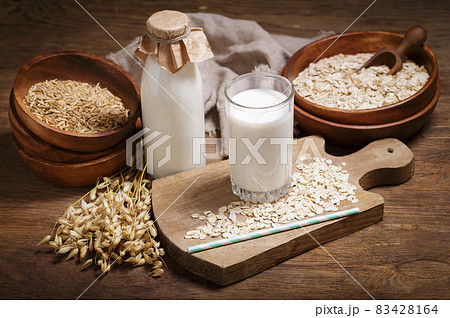 glass of oat milk and oat flakes 83428164