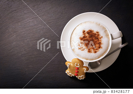 christmas cookie and cup of cappuccino on dark background, 83428177
