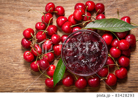 bowl of cherry jam with fresh fruits on a wooden background bowl of cherry jam with fresh fruits on a wooden background 83428293