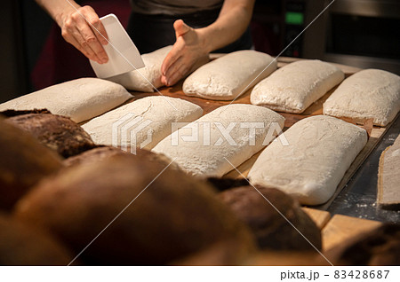 close-up of female hands kneading dough for making artisan bread at home bakery 83428687