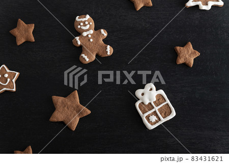 Gift box and stars from gingerbread on black background. Traditional pastries 83431621