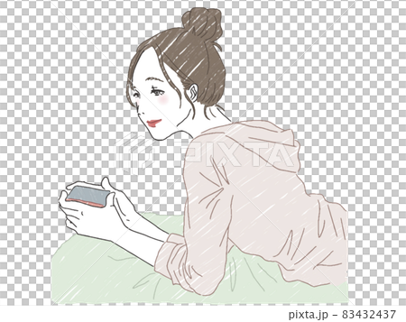 A woman looking at a smartphone while lying down A woman looking at a smartphone while lying down 83432437