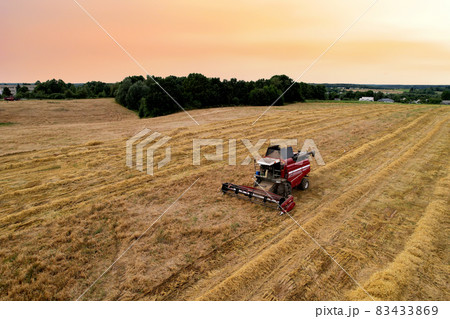 Combine harvester in wheat field on sunset. Combine harvester in wheat field on sunset. 83433869