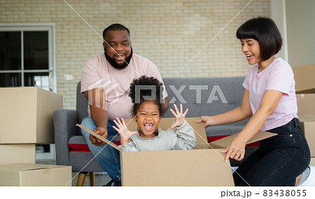 Mixed Race families are sitting on the sofa for rest after moving to a new house on the first day after buying real estate.  Concept of starting a new life for a new family. 83438055