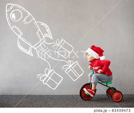 Happy child riding bike. Christmas holiday concept Happy child riding bike. Christmas holiday concept 83439473