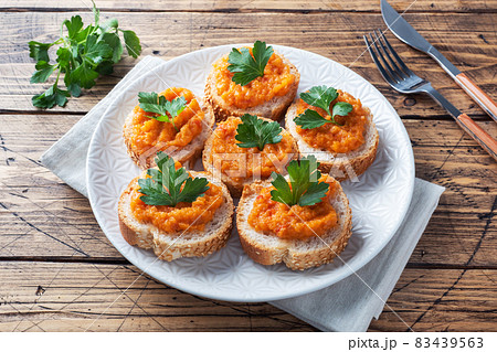 Sandwiches with bread zucchini caviar tomatoes onions. Homemade vegetarian food. Canned stewed vegetable. wooden background Sandwiches with bread zucchini caviar tomatoes onions. Homemade vegetarian food. Canned stewed vegetable. wooden background 83439563