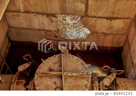 A hole in a concrete bunker for entering a water supply pipeline at a construction site. A hole in a concrete bunker for entering a water supply pipeline at a construction site. 83441235