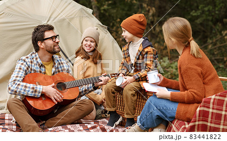 Happy parents and kids enjoying great family camping trip in nature 83441822