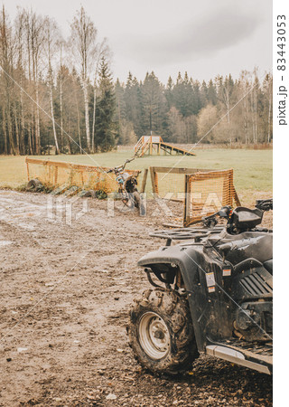 A quad bike and a motorcycle in the mud. 83443053