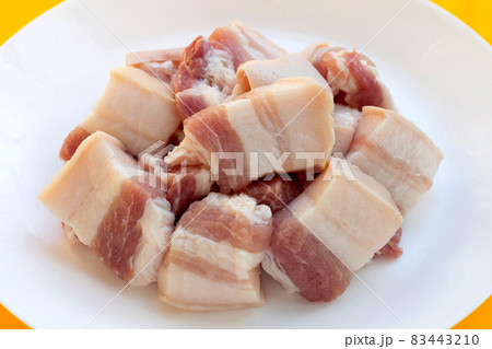 Streaky pork in white plate on yellow background. Streaky pork in white plate on yellow background. 83443210