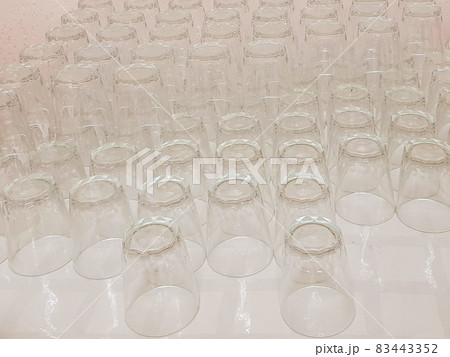 Lots of clean empty glass drinks glasses on the table, service in the hotel cafe Lots of clean empty glass drinks glasses on the table, service in the hotel cafe 83443352