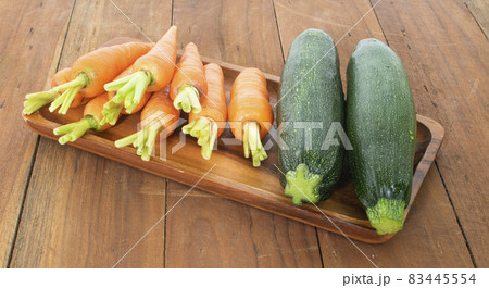 Carrot isolated on wood background Carrot isolated on wood background 83445554