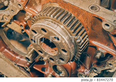 High Angle Zoom View of Crankshaft Gear in Front of Car Engine in Vintage Tone 83447270