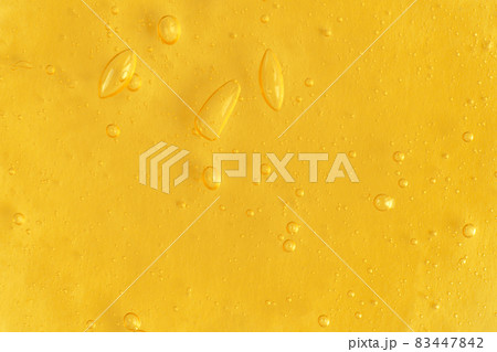 Texture of transparent yellow antiseptic gel with air bubbles on light monochrome background. Concept of skin moisturizing and prevention of virus. Liquid beauty product closeup. Backdrop, flat lay Texture of transparent yellow antiseptic gel with air bubbles on light monochrome background. Concept of skin moisturizing and prevention of virus. Liquid beauty product closeup. Backdrop, flat lay 83447842