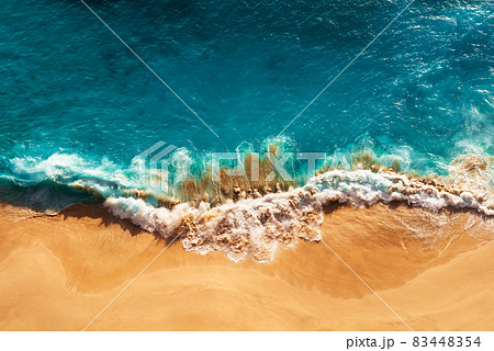 Relaxing aerial beach scene, summer vacation holiday template banner. Waves surf with amazing blue ocean lagoon, sea shore, coastline. Perfect aerial drone top view. Peaceful bright beach, seaside 83448354
