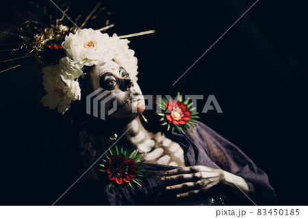 Woman with mexican skull halloween makeup on her face. Day of the dead and halloween 83450185