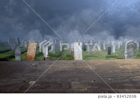 Wooden table with tombstones on the graveyard with night scene background Wooden table with tombstones on the graveyard with night scene background 83452036