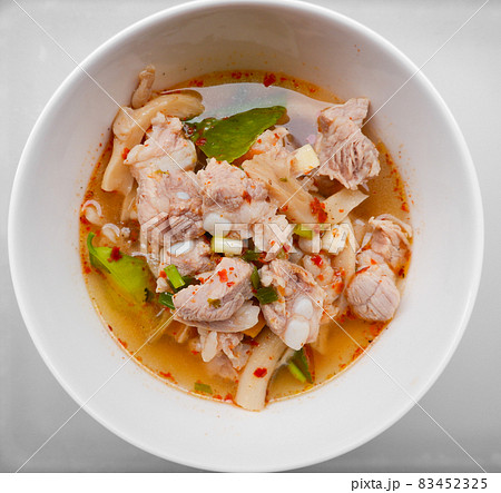 Spicy and sour Thai food called Fiery Pork Ribs Broth. in a white cup on the dining table, Top view. 83452325