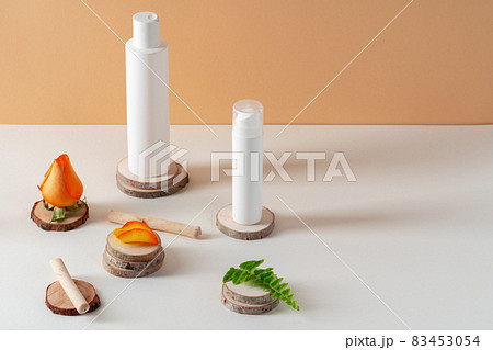 Cosmetics containers decorated with orange rose petals 83453054