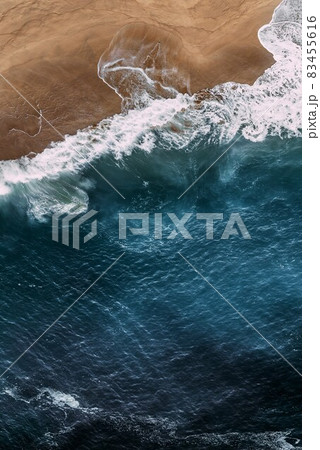 Beautiful sea background for your smartphone. Beautiful sandy beach with blue ocean, vertical view. Seascape from a quadrocopter. Beautiful seascape background. Sandy beach on the island. Copy space Beautiful sea background for your smartphone. Beautiful sandy beach with blue ocean, vertical view. Seascape from a quadrocopter. Beautiful seascape background. Sandy beach on the island. Copy space 83455616