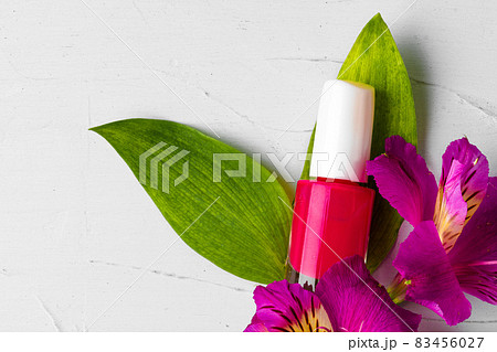 Pink nail polish bottle with flower buds Pink nail polish bottle with flower buds 83456027