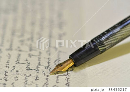 Fountain pen on a blurred letter background. Old fountain pen on an vintage handwritten letter. Conceptual background on history, education, literature topics. Retro style Fountain pen on a blurred letter background. Old fountain pen on an vintage handwritten letter. Conceptual background on history, education, literature topics. Retro style 83456217