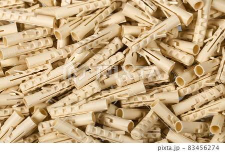 Bunch of beige plastic dowels 83456274
