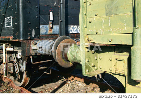 Old fashioned rusty railway freight train coupling buffers 83457375