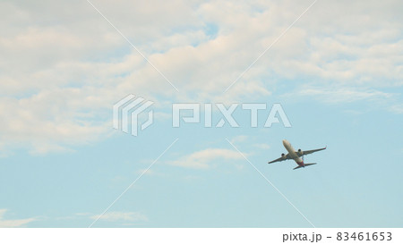 Passenger airplane takes off against the blue sky with clouds. 83461653
