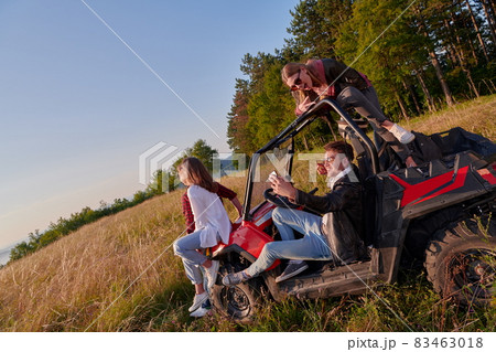 group young happy people enjoying beautiful sunny day while driving a off road buggy car group young happy people enjoying beautiful sunny day while driving a off road buggy car 83463018
