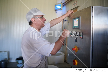 Cheese production cheesemaker working in factory Cheese production cheesemaker working in factory 83463056