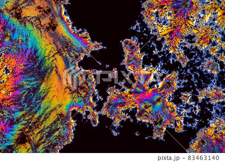 Extreme macro photograph of Vitamin C crystals forming abstract modern art patterns, when illuminated with polarized light, under a microscope objective with 10x magnification Extreme macro photograph of Vitamin C crystals forming abstract modern art patterns, when illuminated with polarized light, under a microscope objective with 10x magnification 83463140