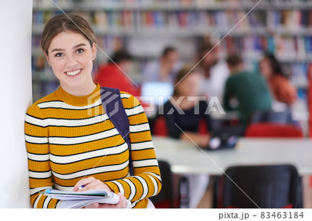 the student uses a notebook and a school library 83463184