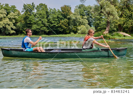 friends are canoeing in a wild river 83463241