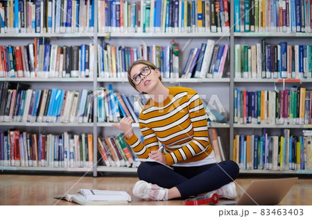 the student uses a notebook and a school library 83463403