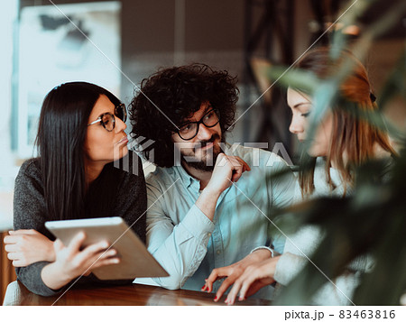 A group of friends hanging out in a cafe, and talking about business A group of friends hanging out in a cafe, and talking about business 83463816