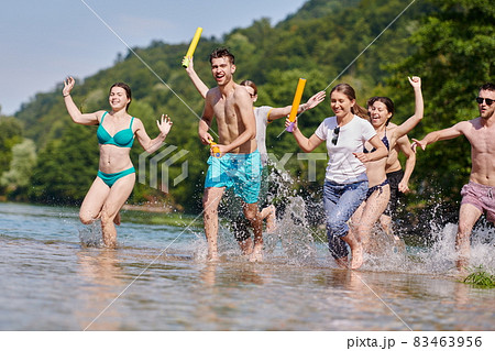 group of happy friends having fun on river 83463956