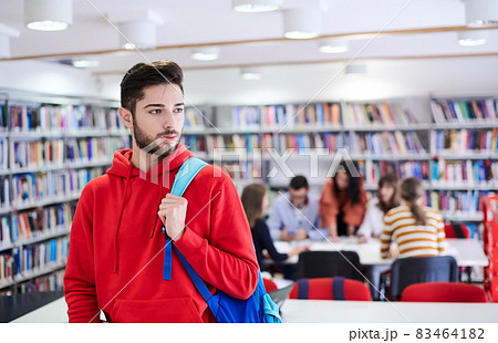 the student uses a laptop and a school library 83464182