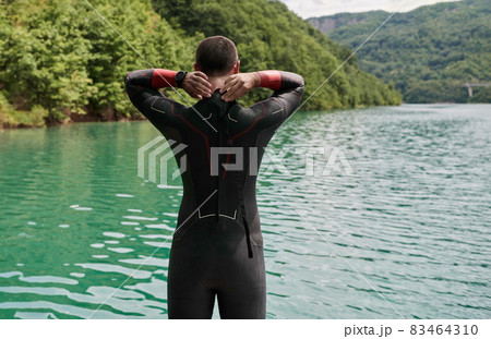 triathlon athlete getting ready for swimming training on lake 83464310